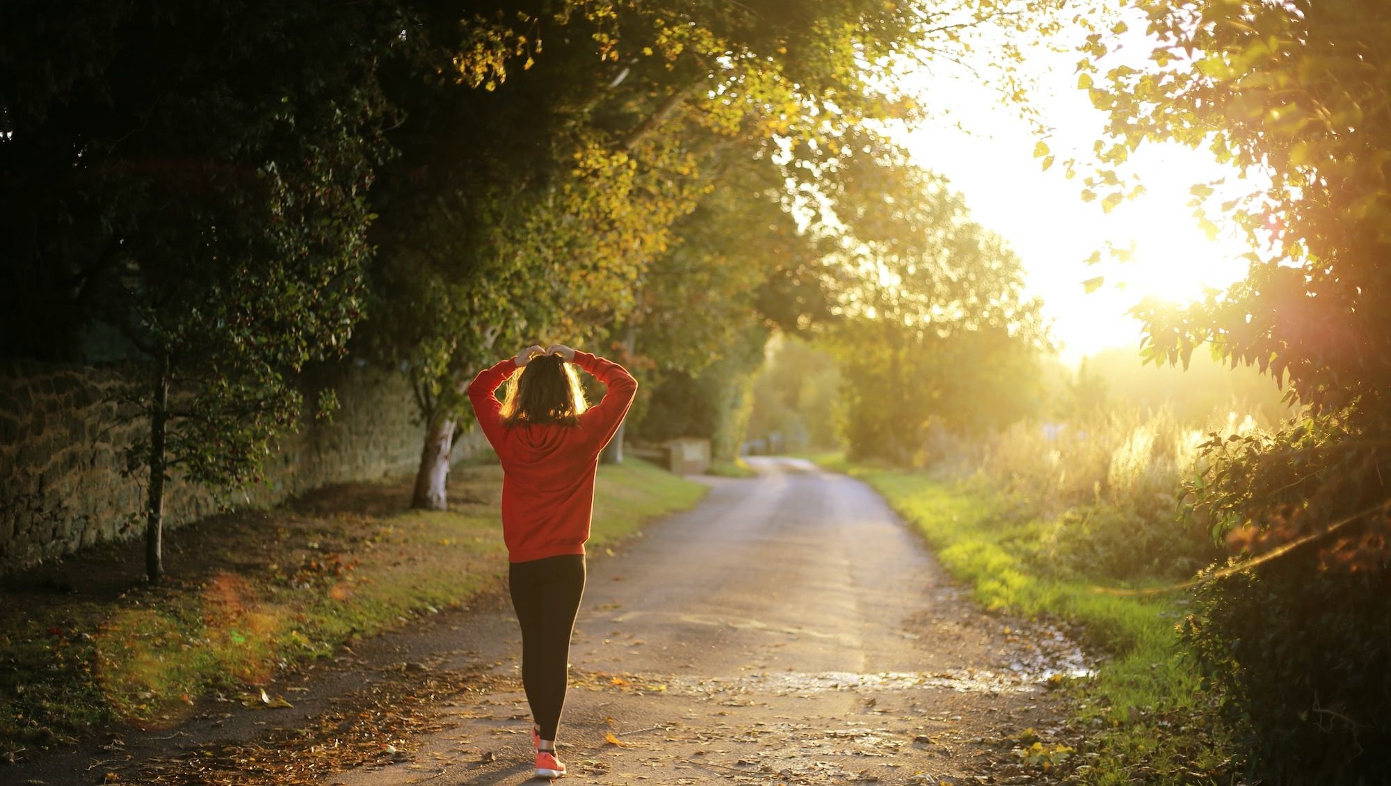 woman walking on pathway during daytime